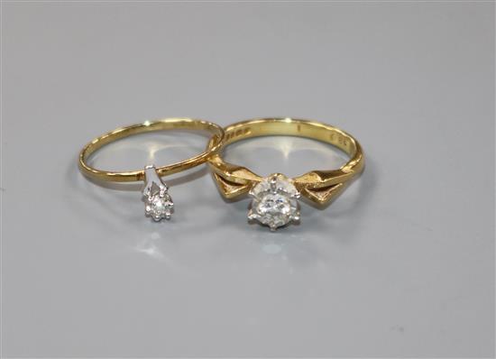 An 18ct gold and illusion set solitaire diamond ring and a small 14ct gold diamond ring.